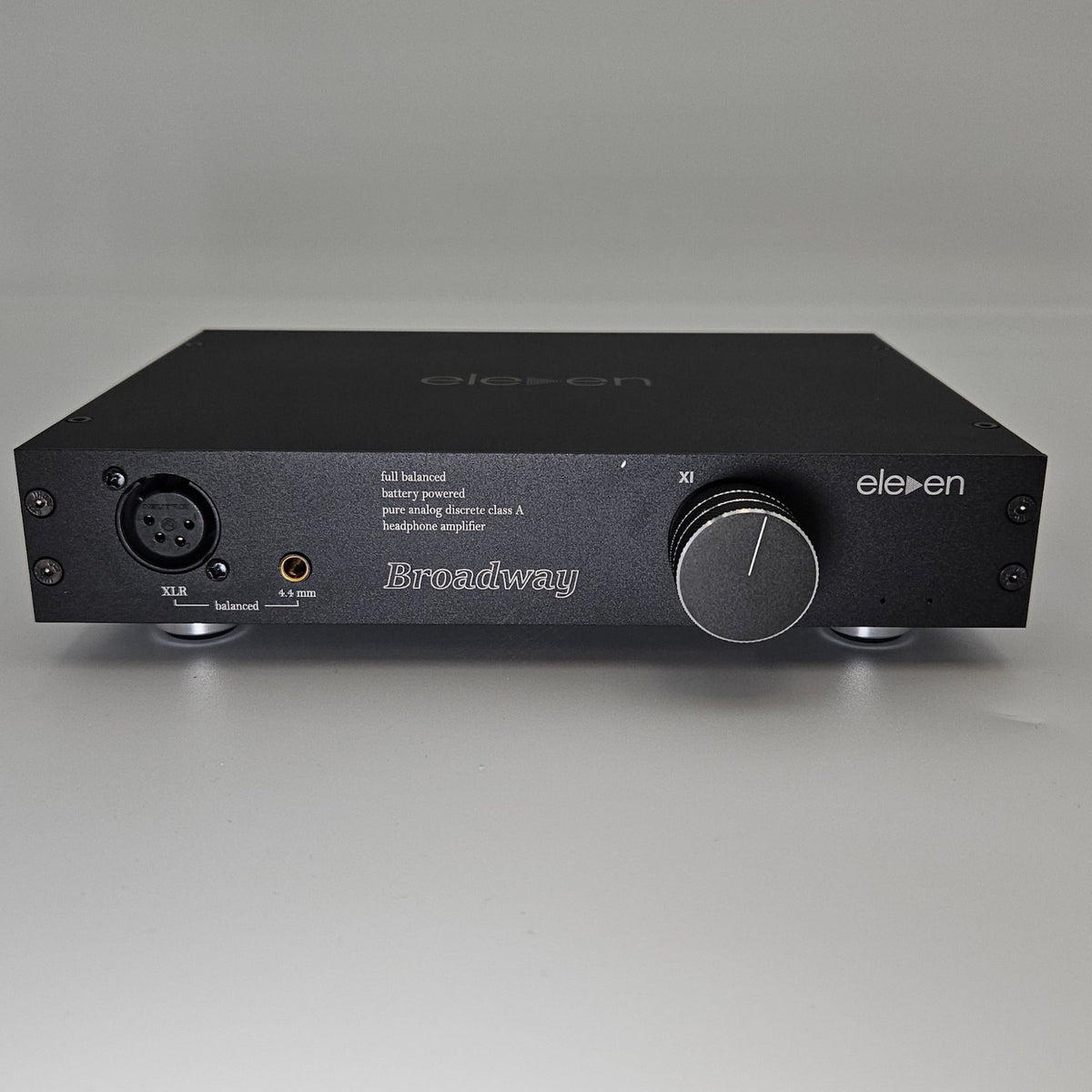 Black audio interface with a knob on a white background